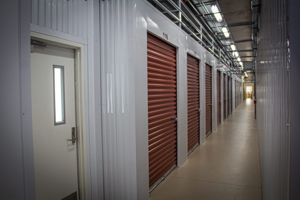 A row of storage units with doors open.